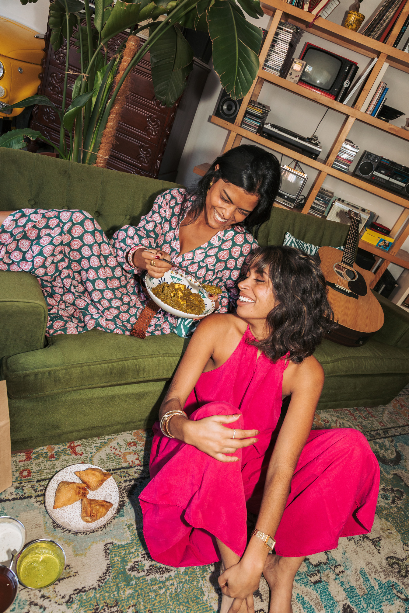 Two Female Friends Eating Indian Takeaway Food