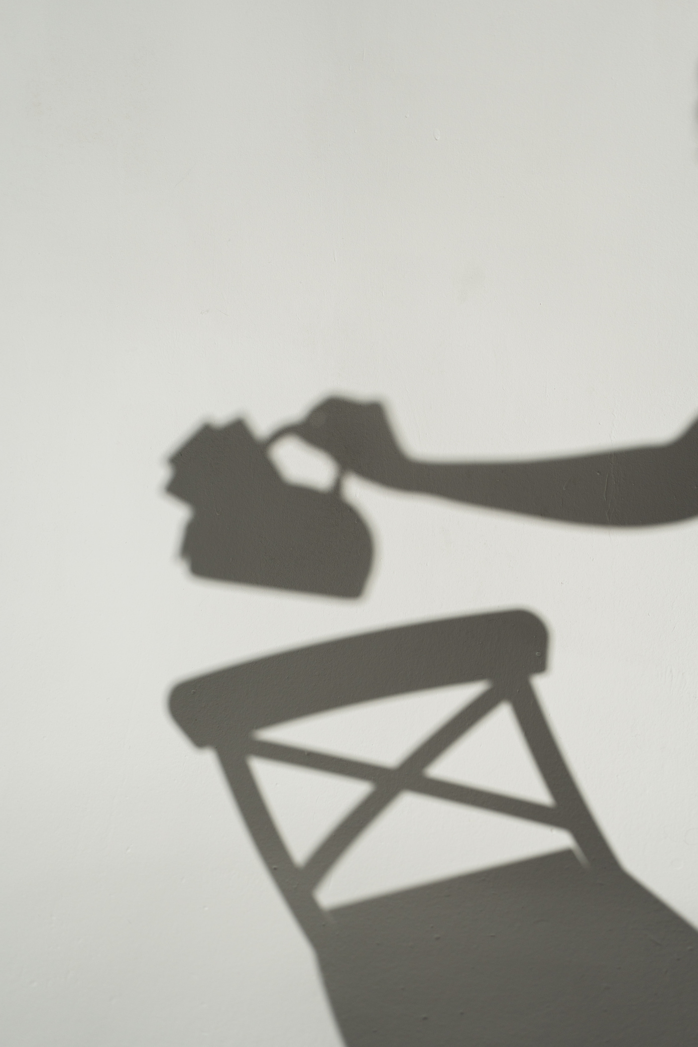 Shadow of a Person's Hand Holding a Bag with Cash